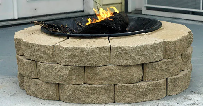 DIY Brick Fire Pit on a Budget - This project is easy to make and because its made of brick it is a sturdy pit. You will have no worries about looters stealing the metal one.