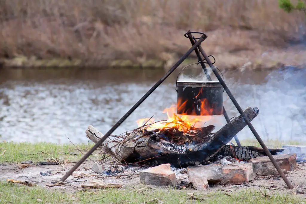 boiling water over an open fire to make it safe to drink