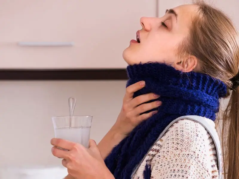 Woman gargling with salt water