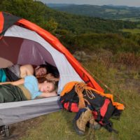 Young couple sleeping in a tent