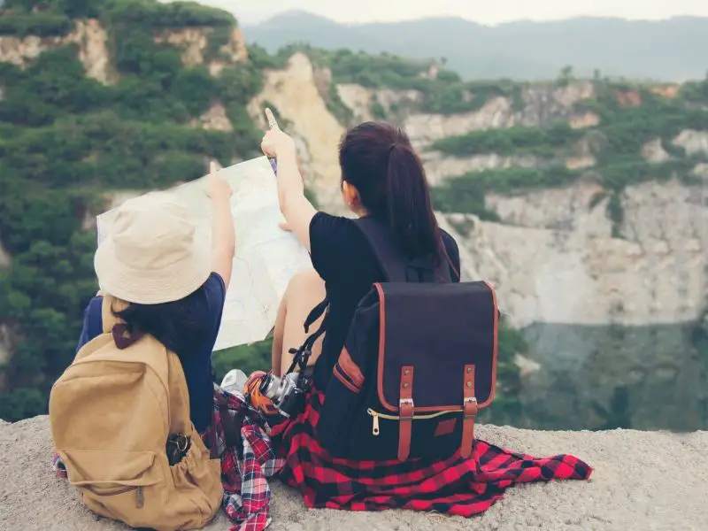 Girl planning a backpacking route with her mom