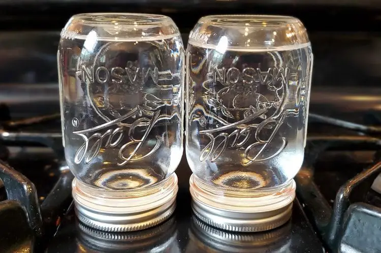 inverted mason jars with water ready for canning