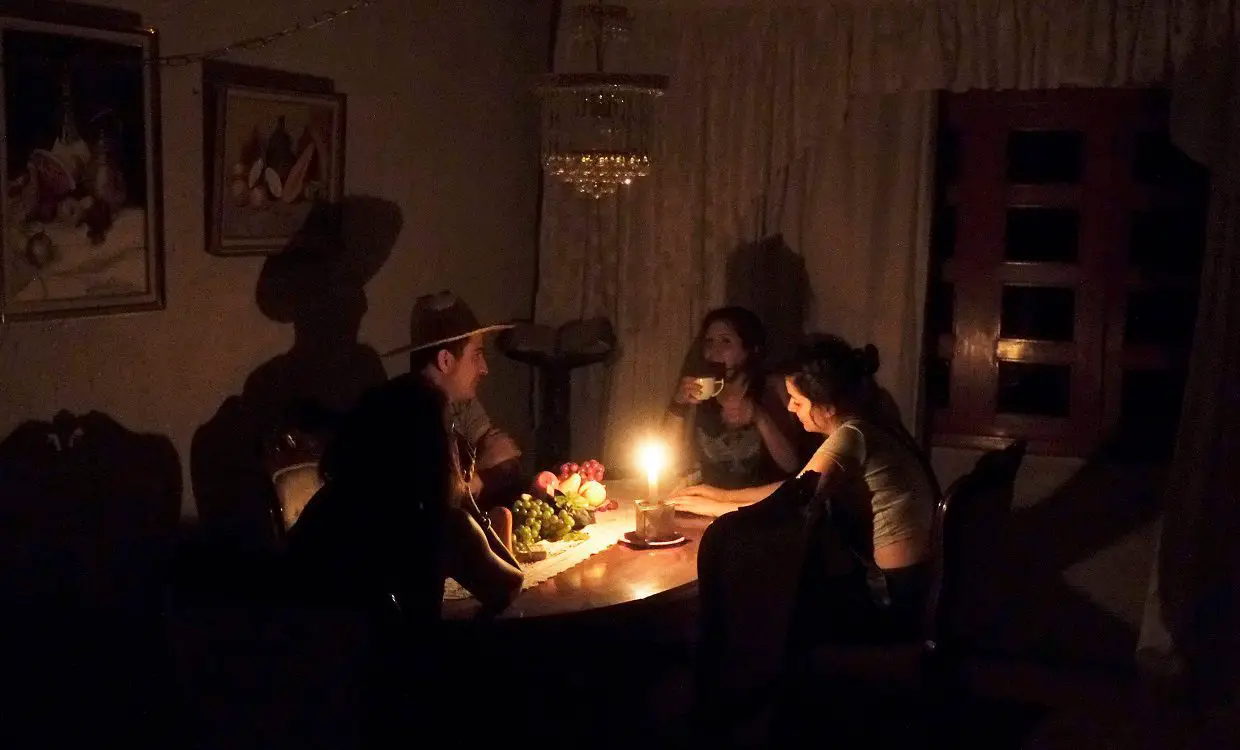 Family around dinning table during power outage