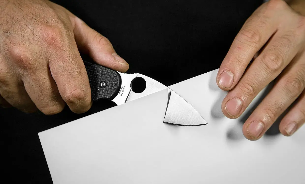 Checking the sharpness of pocket knife blade is final step