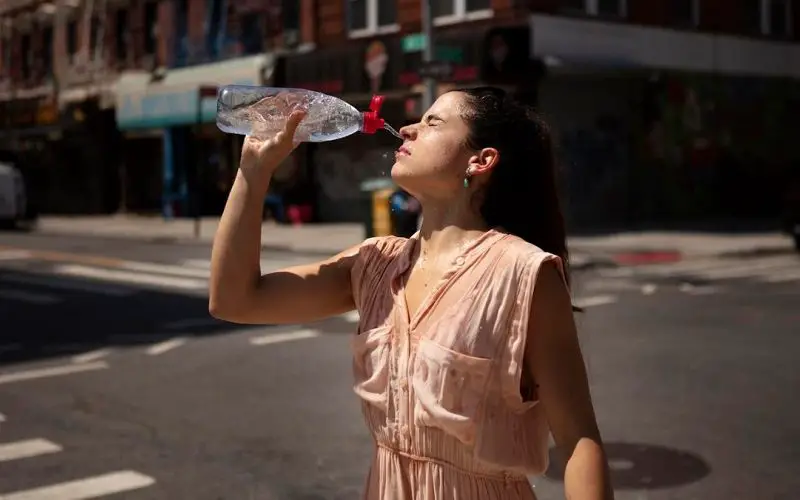How to Survive a Heat Wave: Learn the Basics 3 drinking water on a hot day