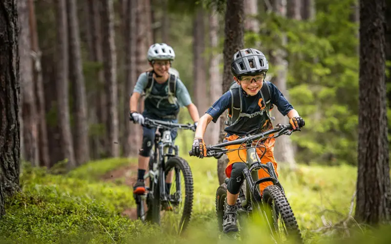9 Camping Activities for Kids: Make Memories in Nature 3 kids riding mountain bikes