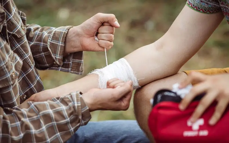 12 Essential Camping Skills for Outdoor Survival 3 using first aid kit